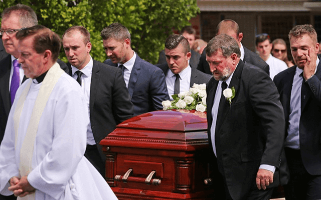 Phillip Hughes’ coffin being carried by his father and Aaron Finch