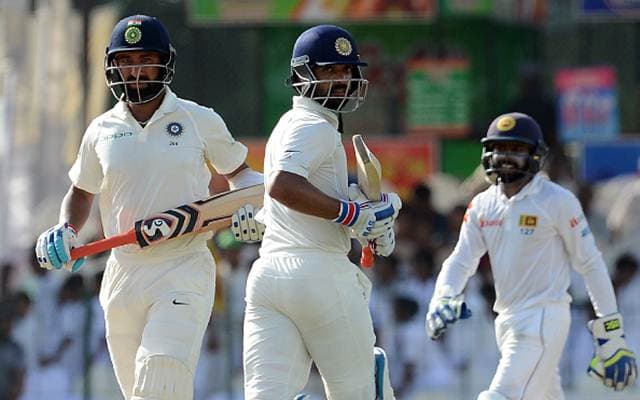 Ajinkya Rahane (C) and teammate Cheteshwar Pujara